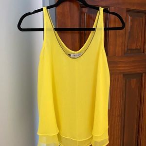 Jennifer Lopez, sunny yellow sleeveless top